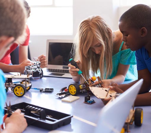 Kids assembling electronics kits in a classroom | Arduino Programming